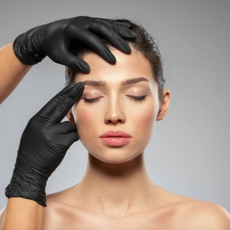 Woman having Botox anti-wrinkle treatment areas marked by doctor in Colchester, Essex