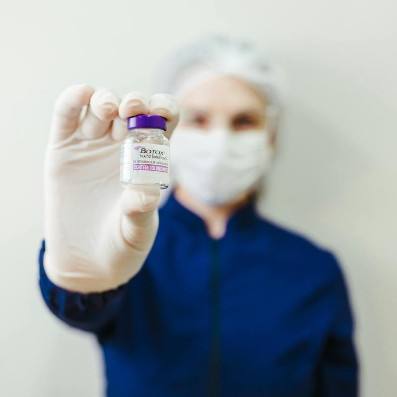 Blurred person holding a vial of Botox – Anti-Wrinkle Injections at Bespoke Medical Aesthetics Colchester