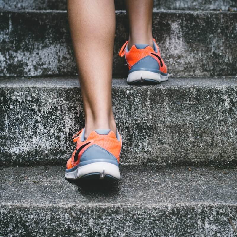 Person running up steps symbolising health and vitality for GlycanAge biological age testing in Colchester