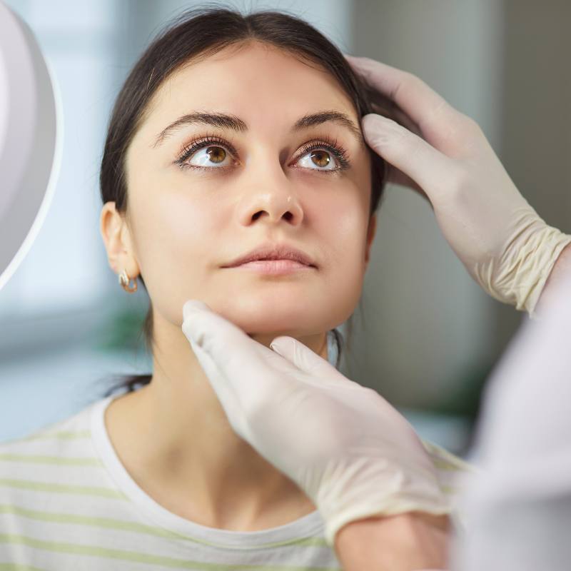 A patient having her face assessed for suitability for treatment with Harmonyca at Bespoke Medical Aesthetics, Colchester.