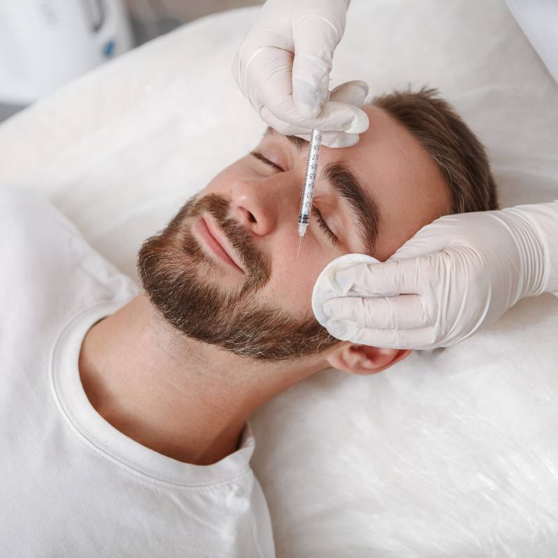 Doctor providing personalised anti-wrinkle treatment consultation for a male patient in Colchester.